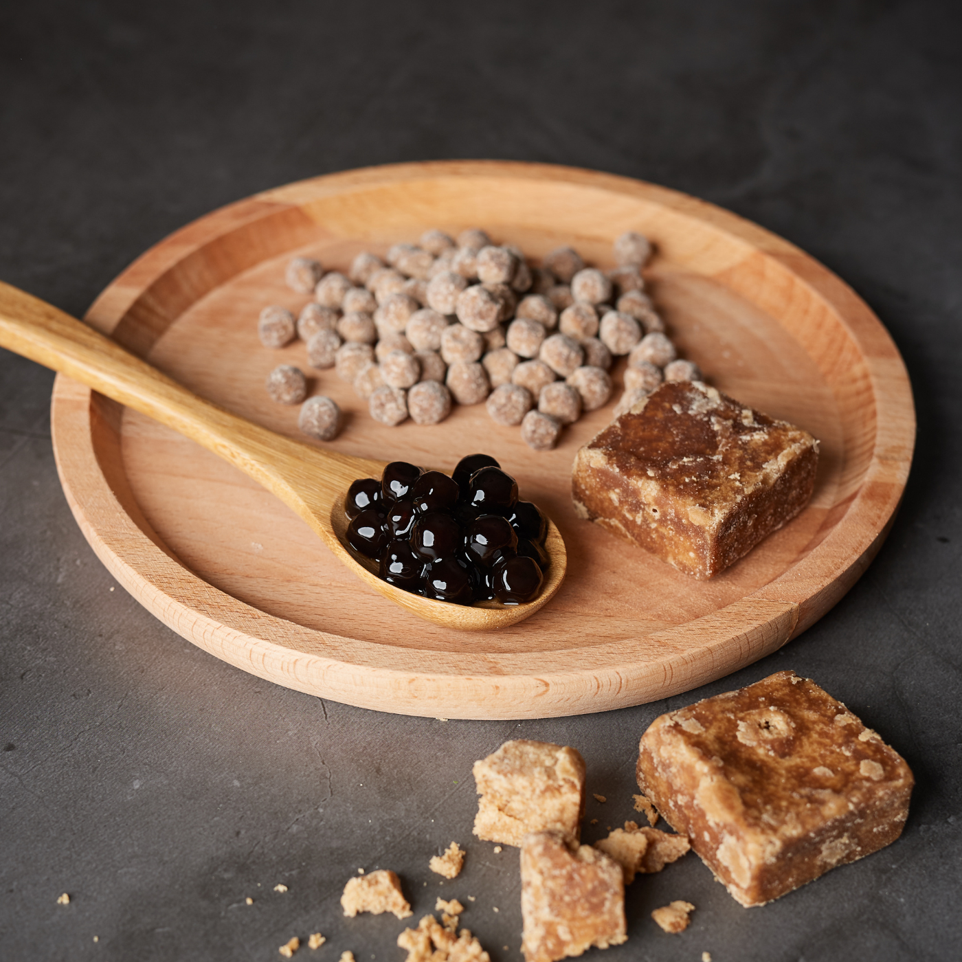 Tapioca Pearls Cooked and uncooked placed on a tray against a dark countertop