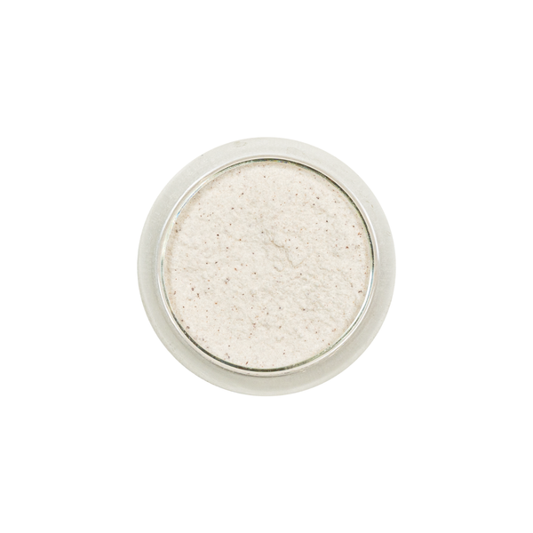 Round container of beige powder with a silver lid on a white background view 4