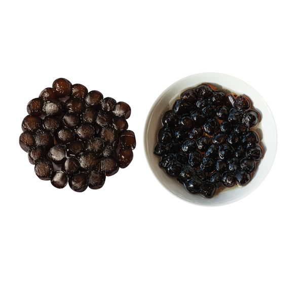 Uncooked and cooked instant tapioca pearls each in a small white bowl on a white background view 2