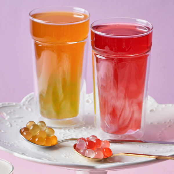 Bubble tea drink with bursting boba placed alongside the drink view 5